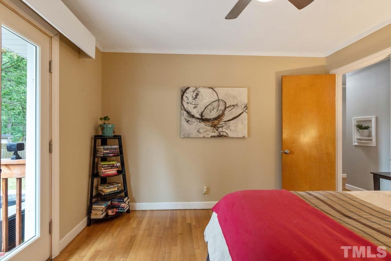2702 Richwood Road Durham, NC 27705 - Photo 15 of 31 a bedroom with a bed and wooden floor