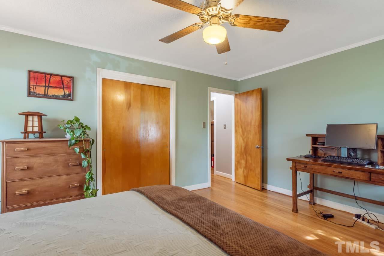 2702 Richwood Road Durham, NC 27705 - Photo 18 of 31 a bedroom with a bed and a dresser in it