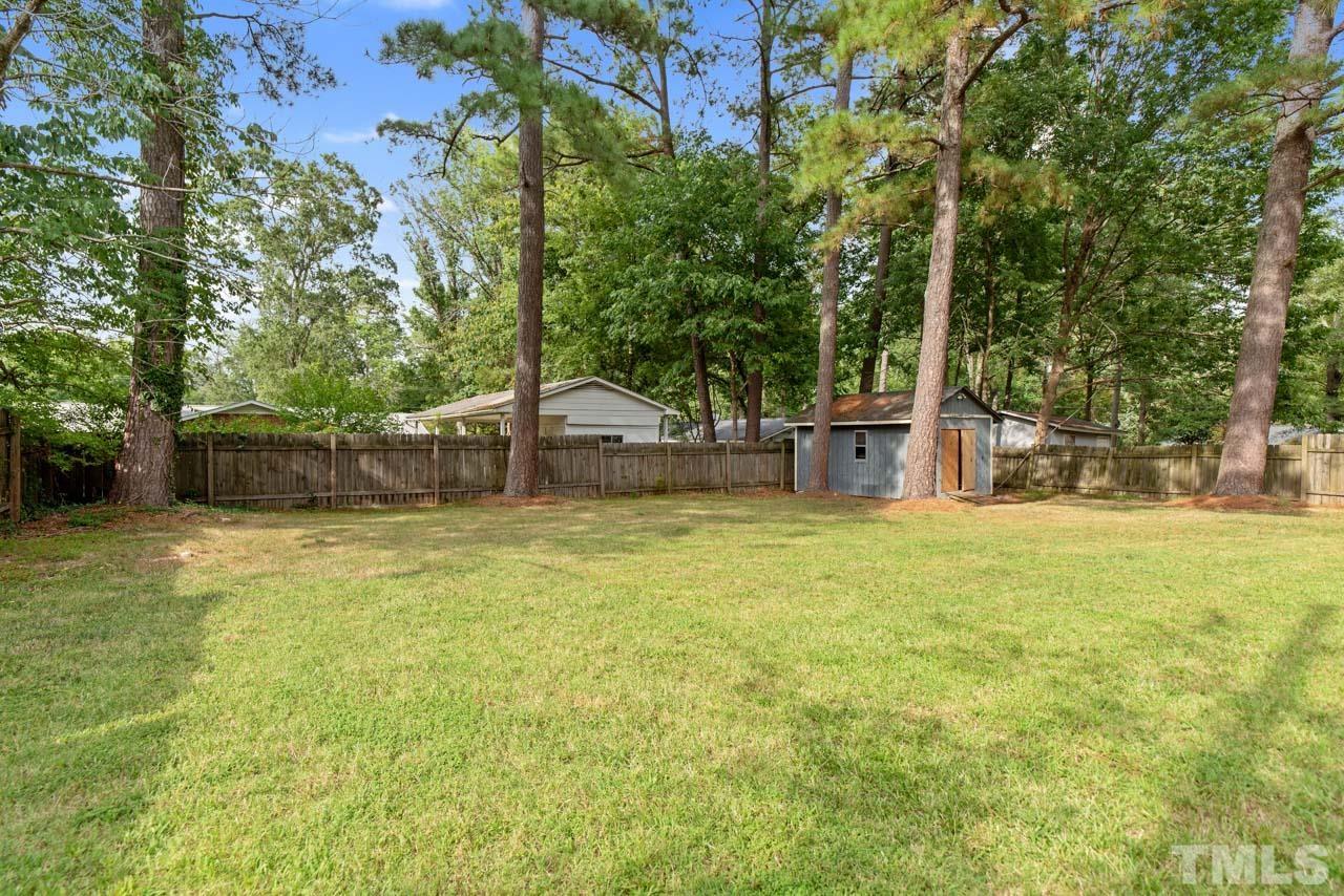 2702 Richwood Road Durham, NC 27705 - Photo 25 of 31 a backyard of a house with trees and outdoor seating