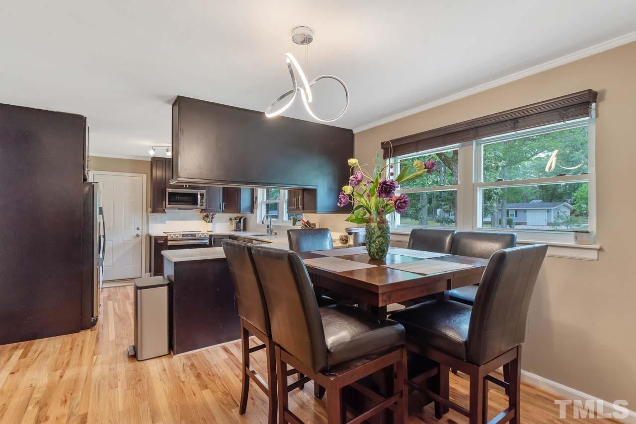 2702 Richwood Road Durham, NC 27705 - Photo 4 of 31 a view of a dining room with furniture window and wooden floor