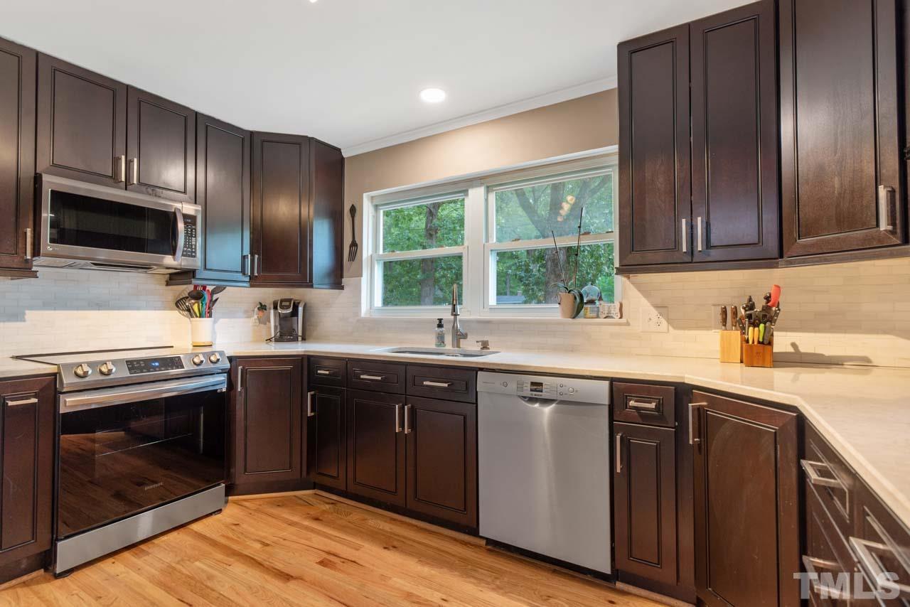 2702 Richwood Road Durham, NC 27705 - Photo 7 of 31 a kitchen with a sink stove and cabinets