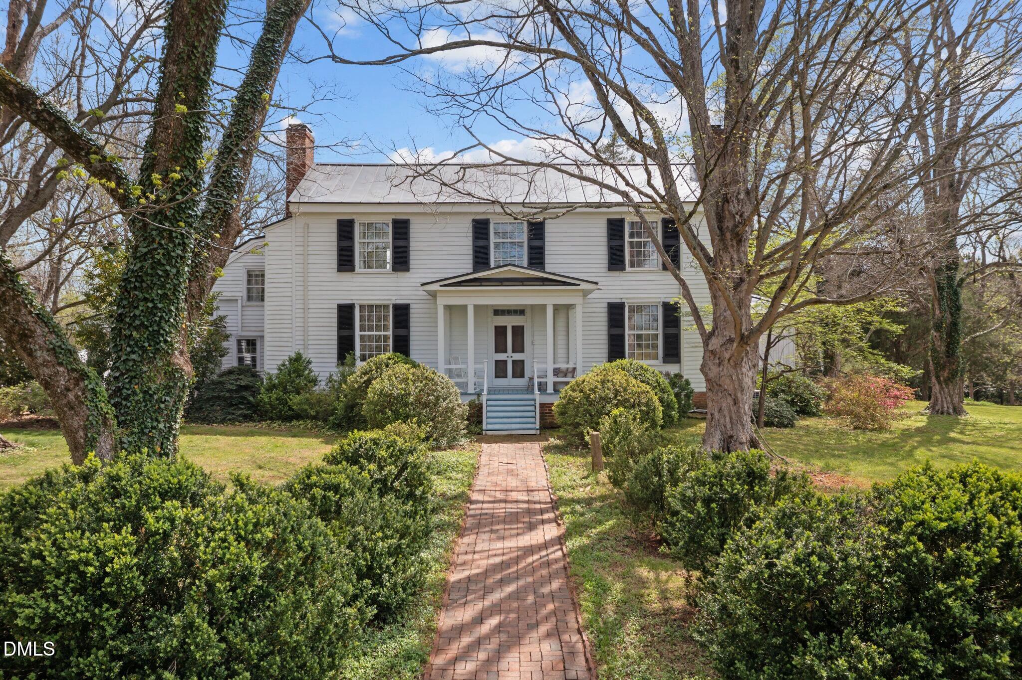 a front view of house with yard and green space