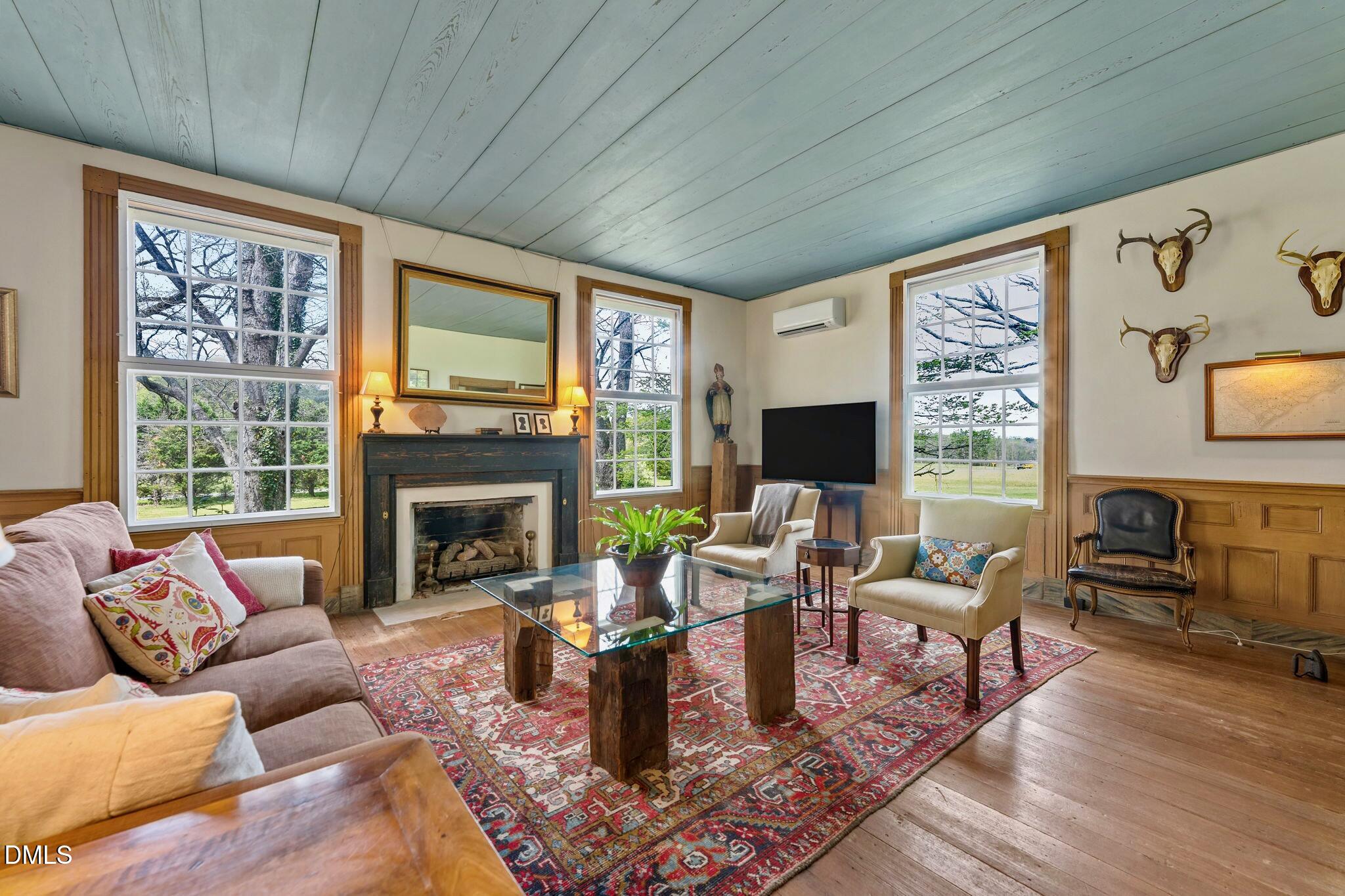 6720 Mebane Oaks Road Mebane, NC 27302 - Photo 11 of 85 a living room with furniture fireplace and a flat screen tv