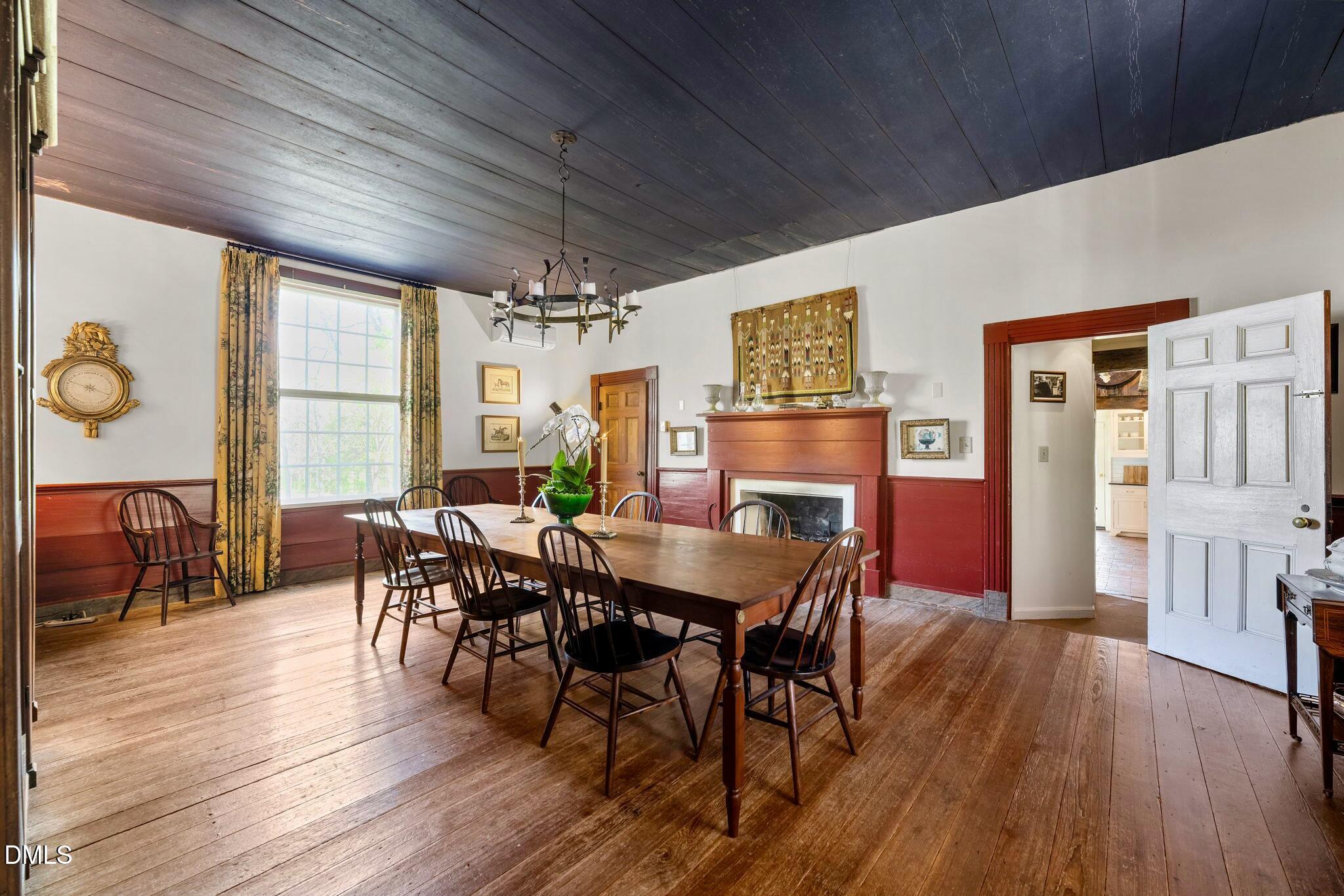 6720 Mebane Oaks Road Mebane, NC 27302 - Photo 16 of 85 a view of a dining room with furniture window and wooden floor