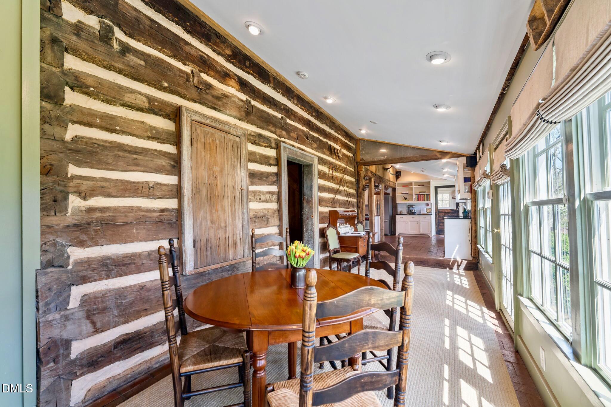 6720 Mebane Oaks Road Mebane, NC 27302 - Photo 29 of 85 a dining room with furniture and a floor to ceiling window