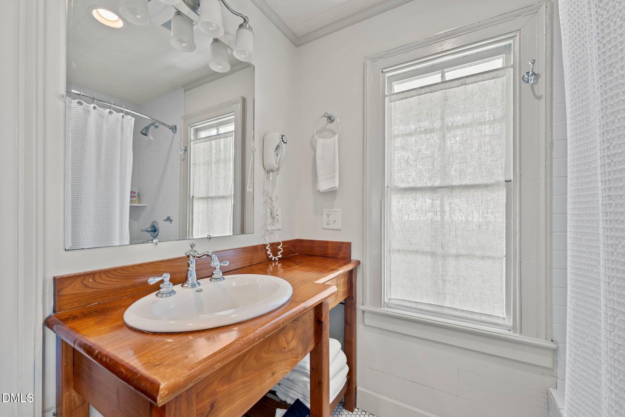 6720 Mebane Oaks Road Mebane, NC 27302 - Photo 37 of 85 a bathroom with a sink and a mirror