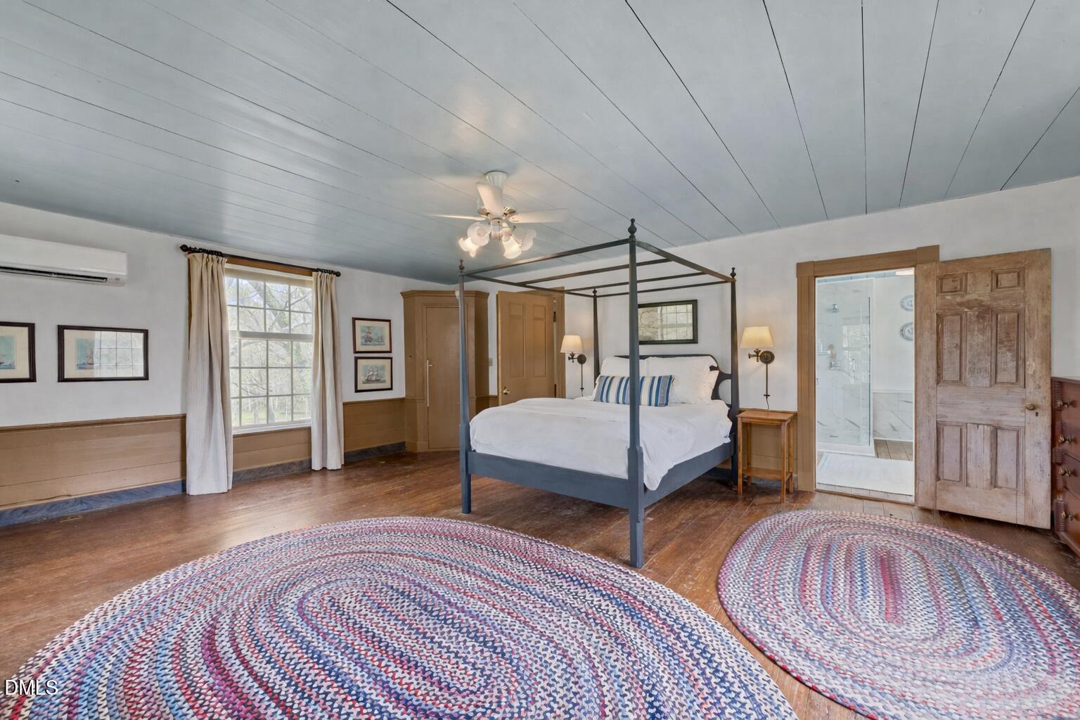 6720 Mebane Oaks Road Mebane, NC 27302 - Photo 50 of 85 a spacious bedroom with a large bed a chandelier and windows