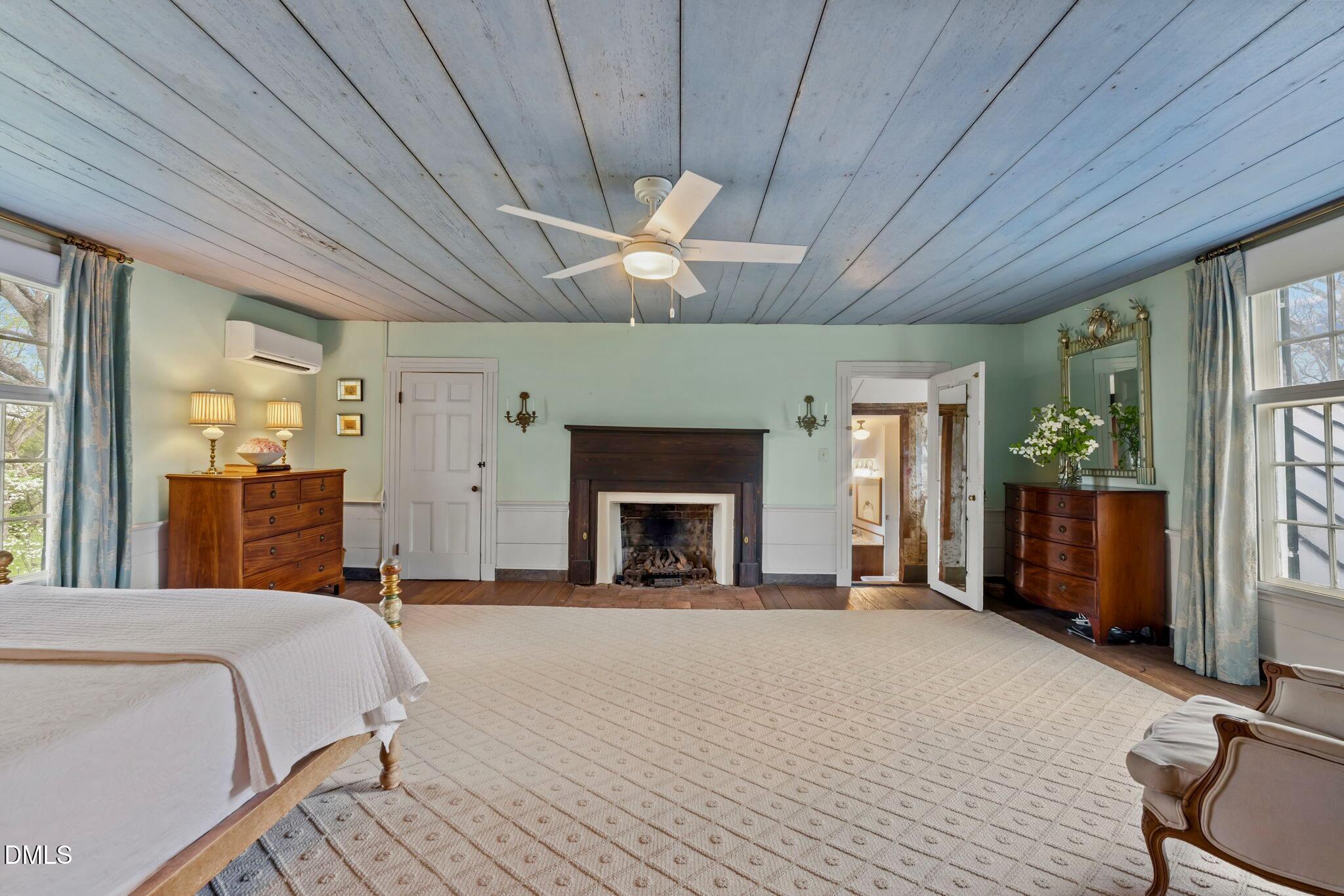 6720 Mebane Oaks Road Mebane, NC 27302 - Photo 53 of 85 a spacious bedroom with a bed and a fireplace