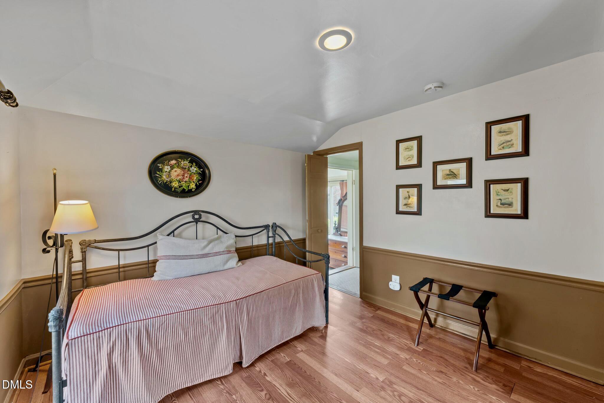 6720 Mebane Oaks Road Mebane, NC 27302 - Photo 61 of 85 a bedroom with a bed and a lamp on table