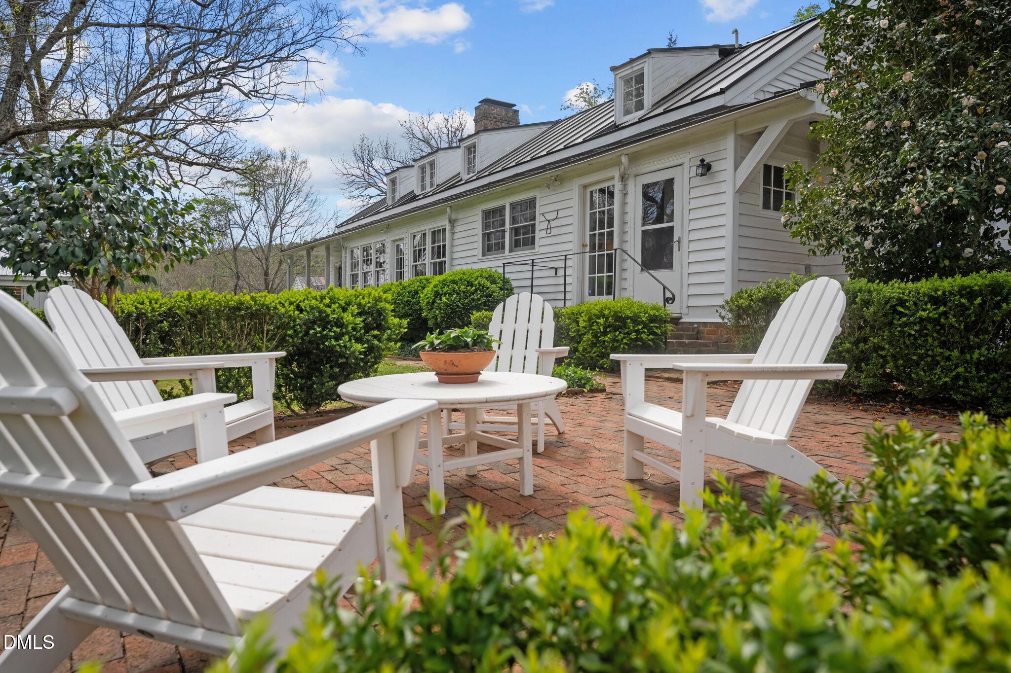 6720 Mebane Oaks Road Mebane, NC 27302 - Photo 68 of 85 a view of a patio with table and chairs and potted plants