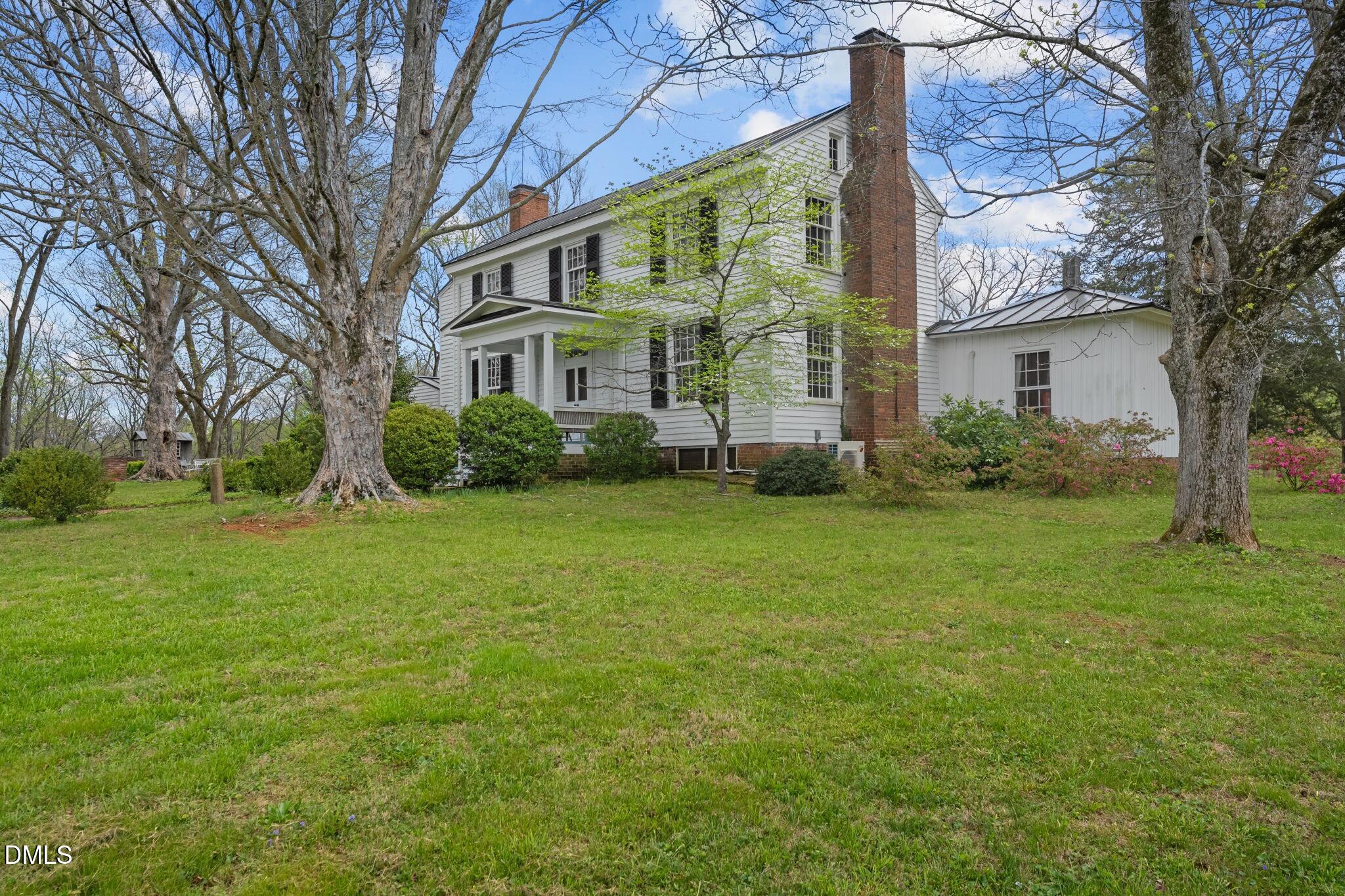 6720 Mebane Oaks Road Mebane, NC 27302 - Photo 80 of 85 a view of a brick house with a big yard and large trees