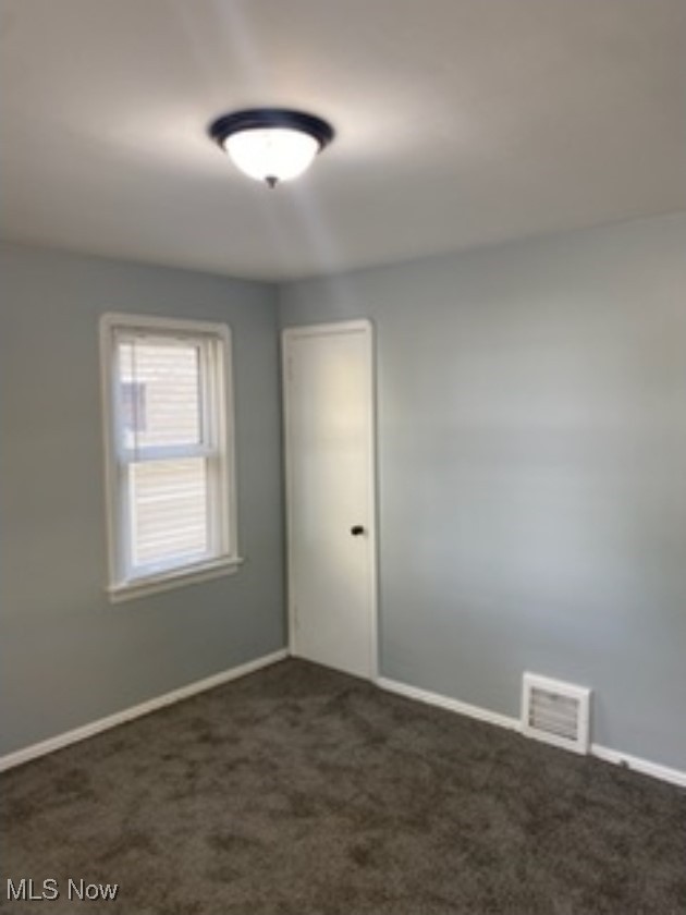 13206 Rockside Road Garfield Heights, OH 44125 - Photo 4 of 15 Empty room featuring dark carpet and baseboards