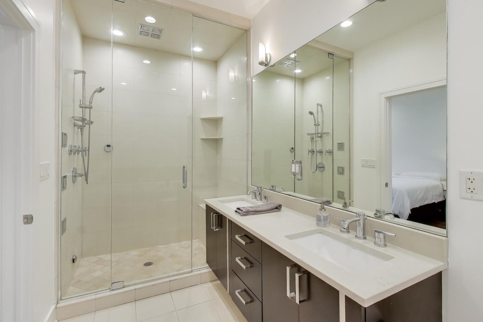 822 West Buckingham Place, Unit 301 Chicago, IL 60657 - Photo 11 of 26 a bathroom with a sink double vanity and a shower
