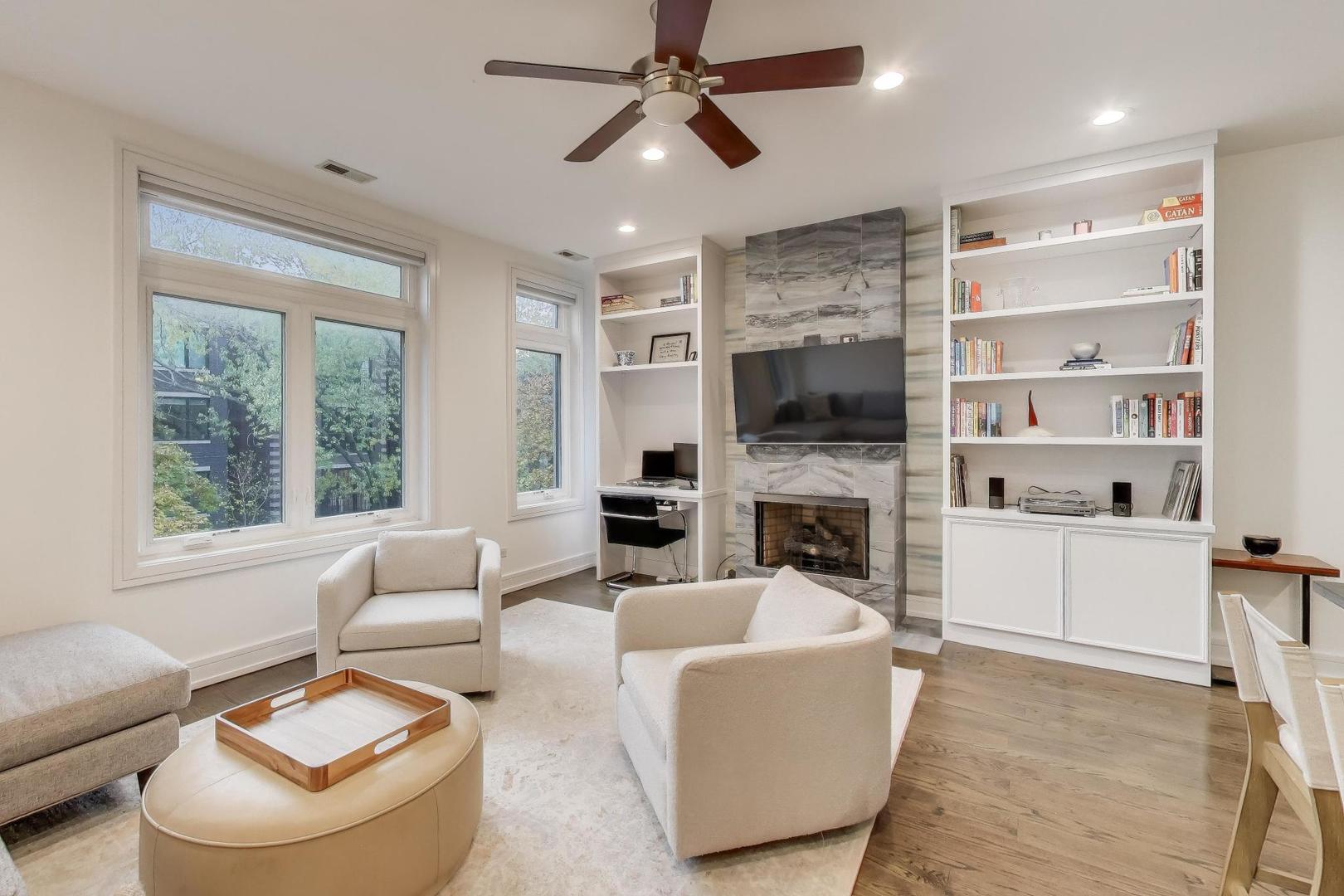 822 West Buckingham Place, Unit 301 Chicago, IL 60657 - Photo 4 of 26 a living room with furniture a fireplace and a flat screen tv