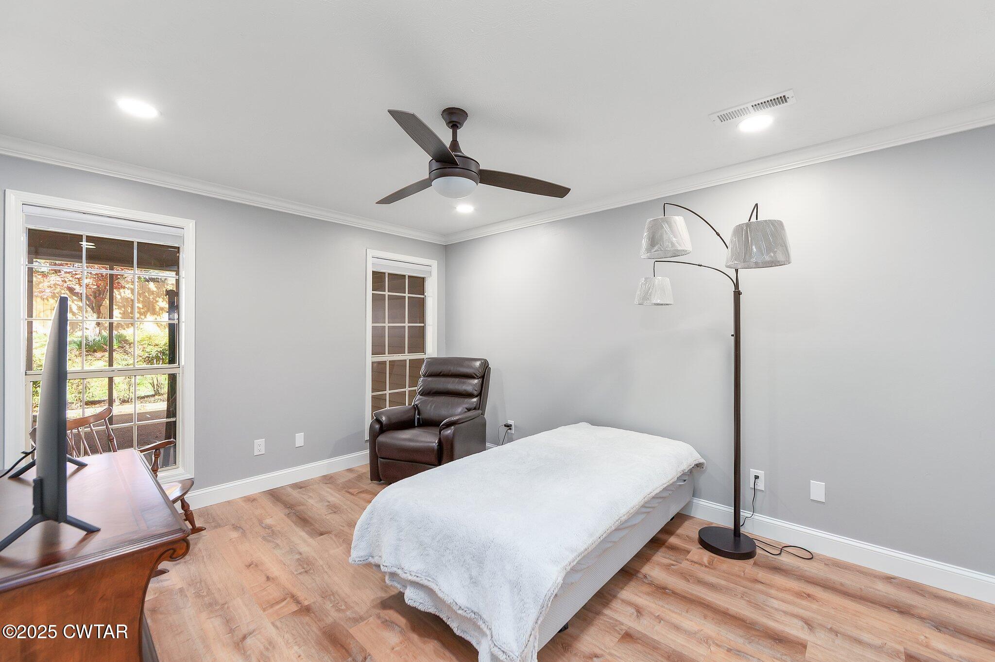 669 Walker Road Jackson, TN 38305 - Photo 16 of 32 a bedroom with a bed and wooden floor