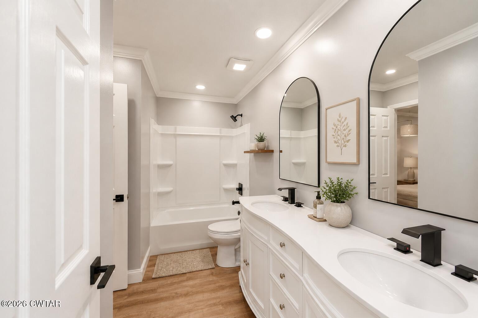669 Walker Road Jackson, TN 38305 - Photo 17 of 32 a bathroom with a double vanity sink a toilet and a mirror