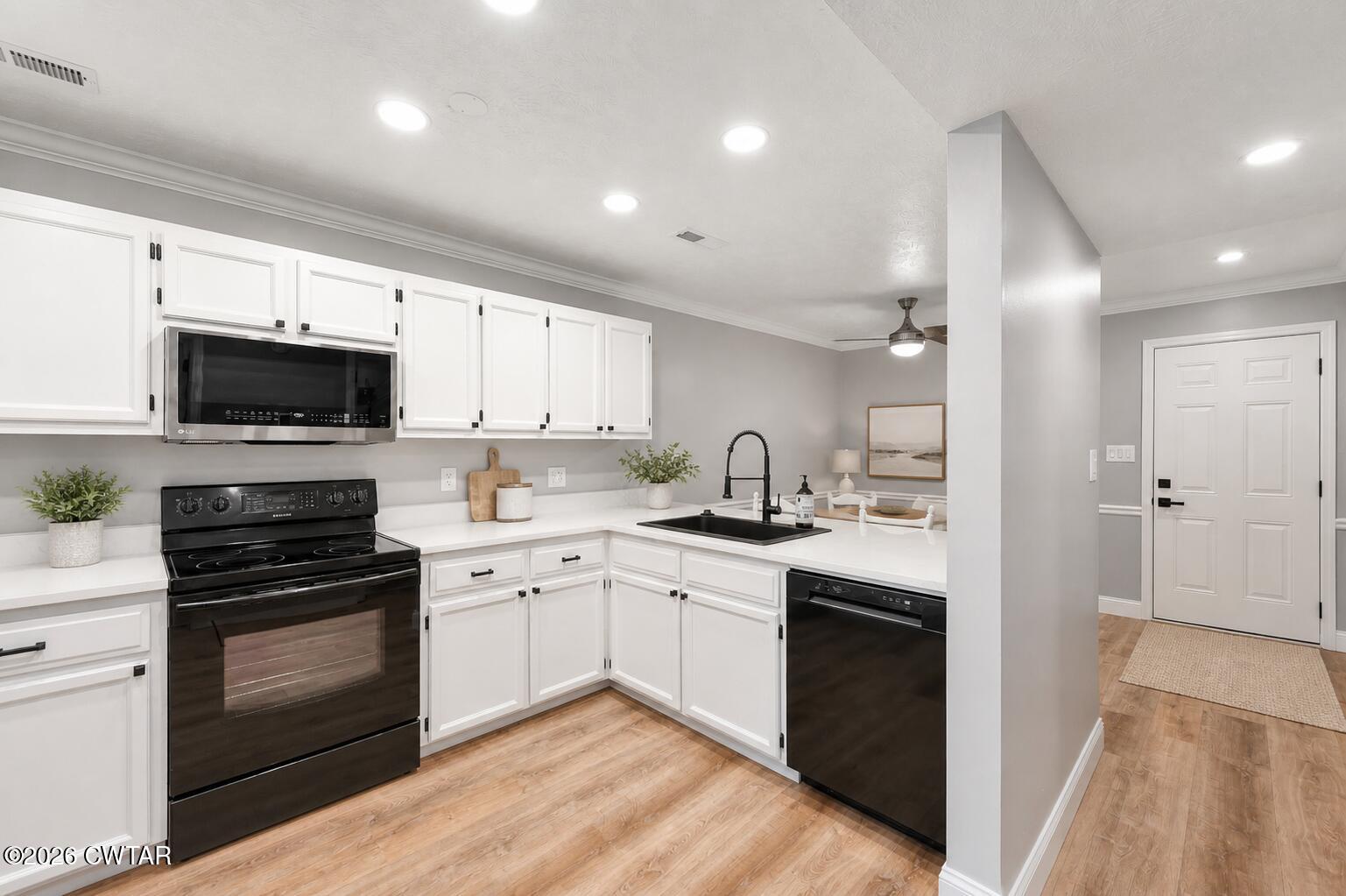 669 Walker Road Jackson, TN 38305 - Photo 7 of 32 a kitchen with white cabinets stainless steel appliances and a sink