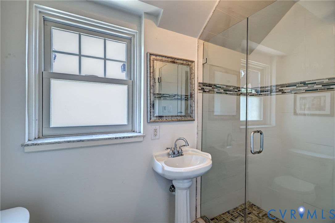 4814 Riverside Drive Richmond, VA 23225 - Photo 28 of 39 a bathroom with a sink and mirror