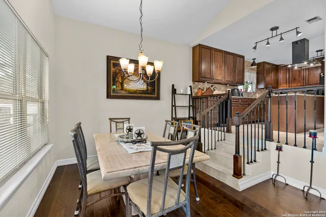 a view of a livingroom with furniture wooden floor windows