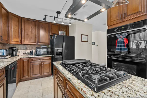 a kitchen with a stove and a refrigerator