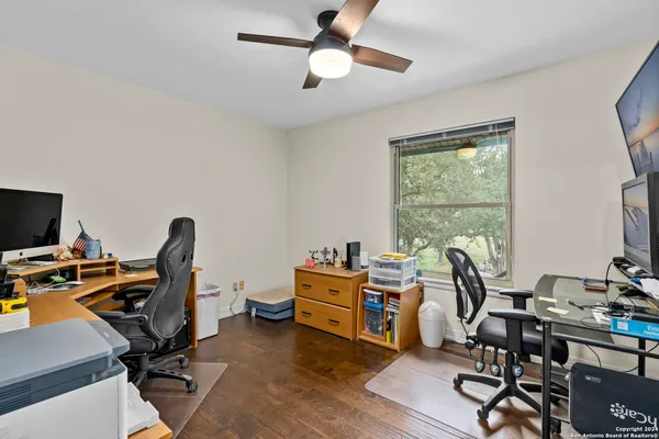 a view of a workspace with furniture and a window