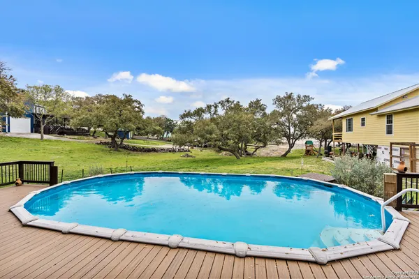 a view of a swimming pool with an outdoor seating and a garden