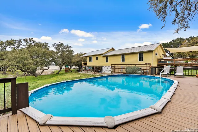a view of a swimming pool with an outdoor seating and a yard