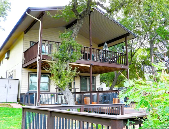 a view of house with a yard and sitting area