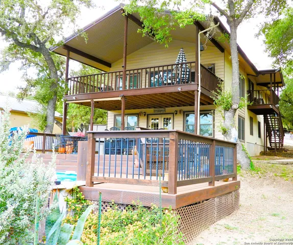 a view of a house with a yard and furniture