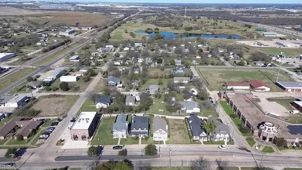 an aerial view of residential houses with outdoor space