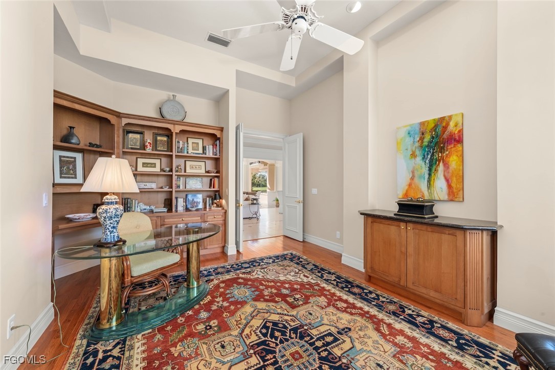 2417 Wulfert Road Sanibel, FL 33957 - Photo 12 of 50 a bedroom with furniture and a book shelf