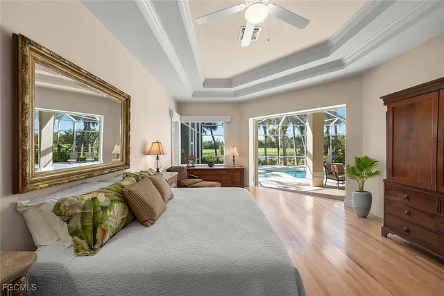 a living room with furniture large windows and wooden floor