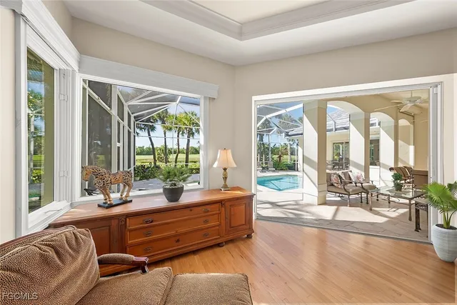 a living room with furniture and floor to ceiling windows