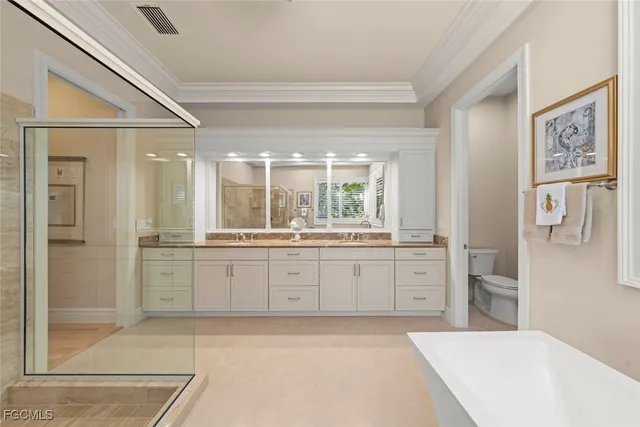 a large bathroom with a granite countertop sink a large mirror a bathtub and next to a window