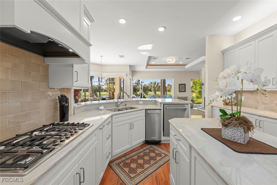 2417 Wulfert Road Sanibel, FL 33957 - Photo 23 of 50 a kitchen with a sink stove and cabinets