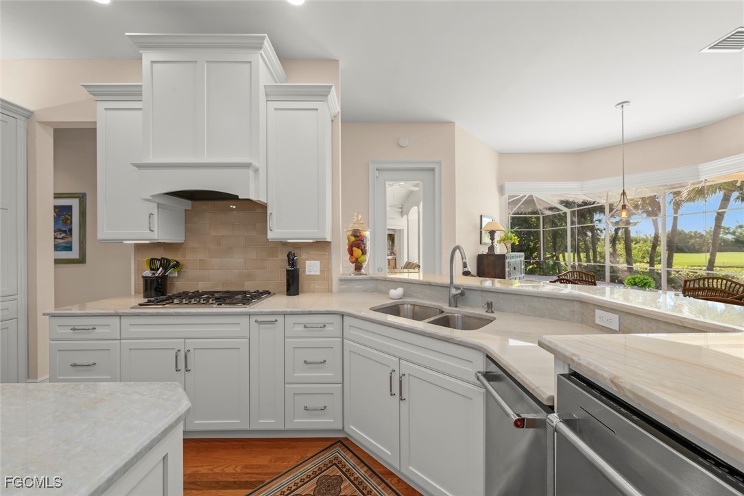 2417 Wulfert Road Sanibel, FL 33957 - Photo 25 of 50 a kitchen with a sink stove and cabinets