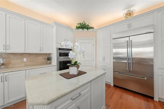 a kitchen with kitchen island a counter top space and cabinets