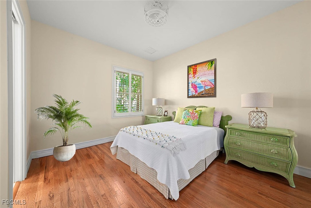 2417 Wulfert Road Sanibel, FL 33957 - Photo 32 of 50 a bedroom with a bed and a potted plant