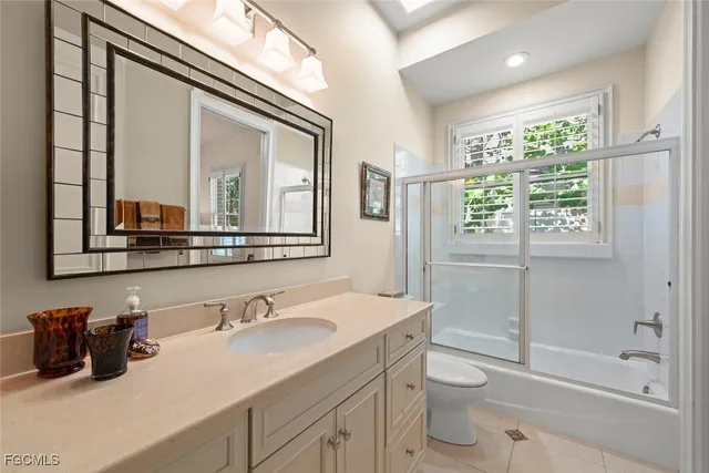a kitchen with granite countertop white cabinets and stainless steel appliances