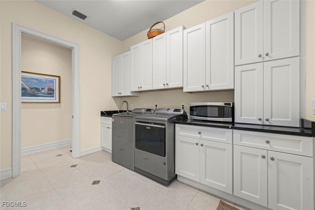 2417 Wulfert Road Sanibel, FL 33957 - Photo 34 of 50 a kitchen with granite countertop white cabinets and stainless steel appliances