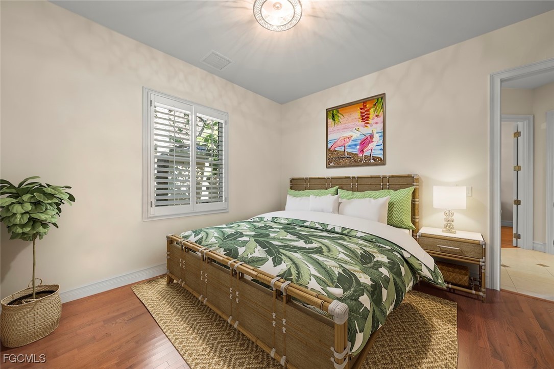 2417 Wulfert Road Sanibel, FL 33957 - Photo 35 of 50 a bedroom with a bed and a potted plant