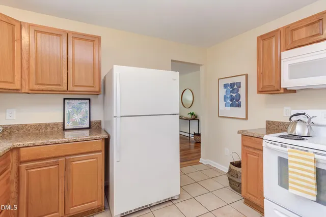 a kitchen with stainless steel appliances granite countertop a refrigerator sink and cabinets