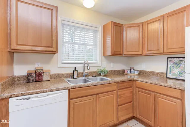 a kitchen with sink cabinets and a window