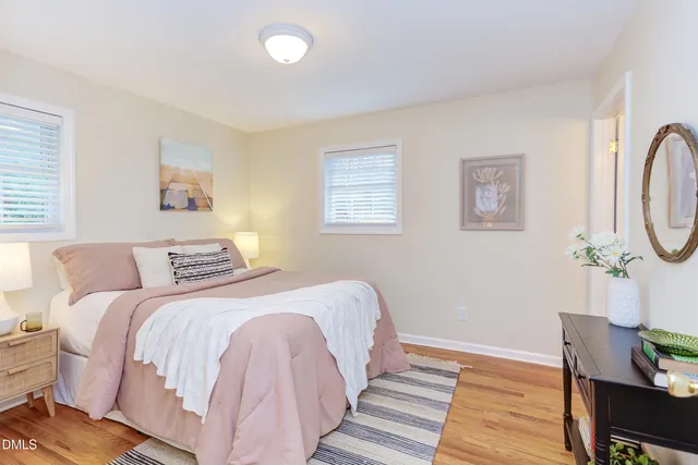 a bedroom with bed and wooden floor