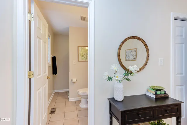 a living room with furniture and a mirror