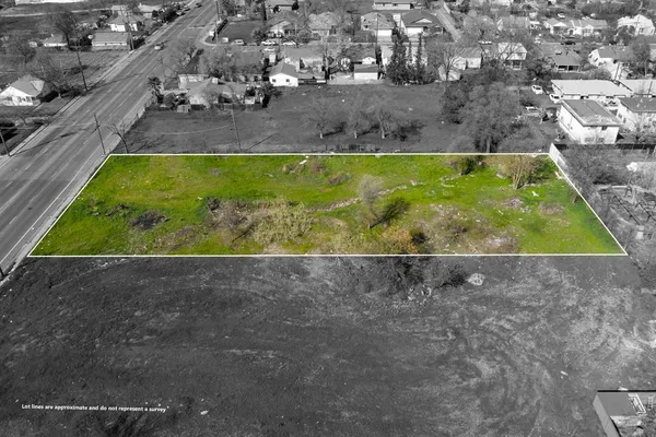 a view of a yard with wooden fence