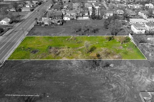 a view of a yard with wooden fence
