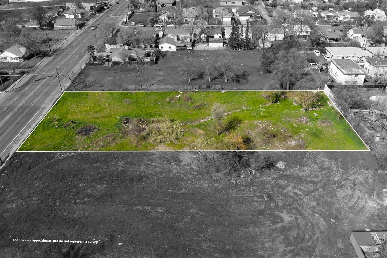 a view of a yard with wooden fence