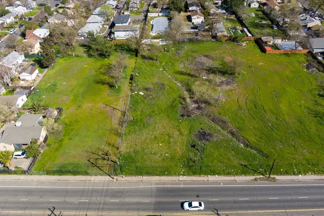 an aerial view of residential houses with yard