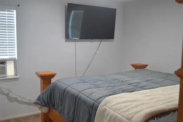 a bedroom with a bed and a chair